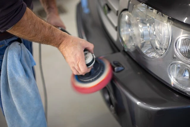 Auto Detailing-man buffing chrome bumper