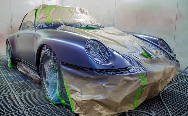 Auto Painting-masked sports car drying after paint job