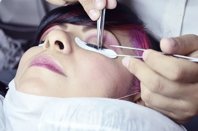 Beauty Salon- Woman treating another woman's eyelashes