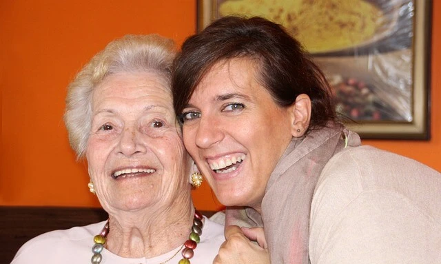 Caregiver Business - Smiling older and younger women posing for photograph