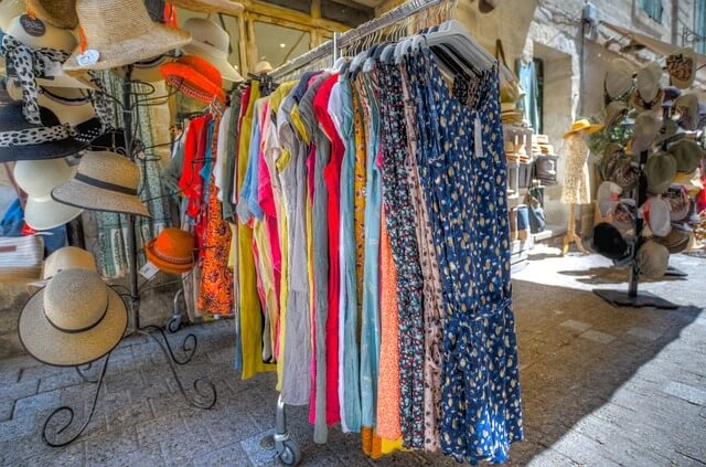 Clothing Boutique - sun dresses hanging on rack on sidewalk