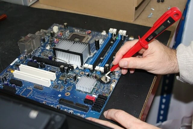 Computer Repair + man's hands test circuit on computer CPU