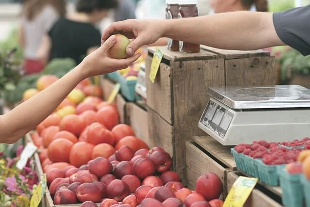 Farmers Market-customer buying fruit from proprietor