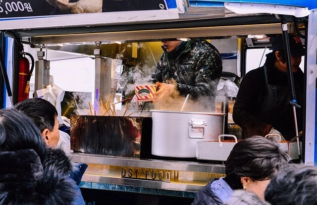 Food Truck-people at counter of food truck with proprietor serving