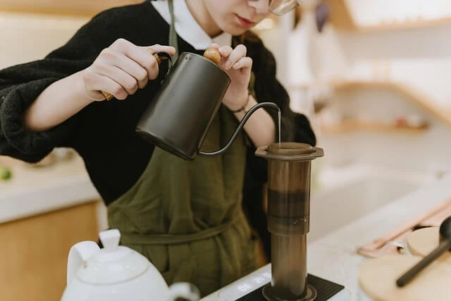 Gourmet Coffee-barista pouring hot water in French press