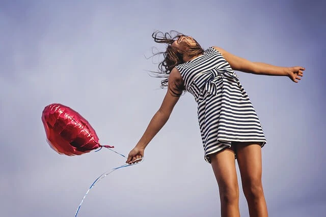 Health Products-Young woman holding heart-shaped balloon