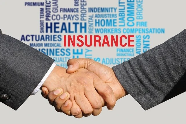Insurance Brokerage-shaking hands with background of words related to insurance
