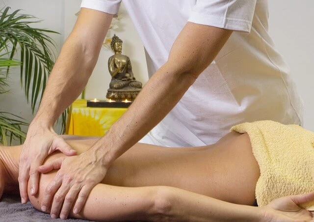 Massage Therapy-Masseur massaging woman's shoulder