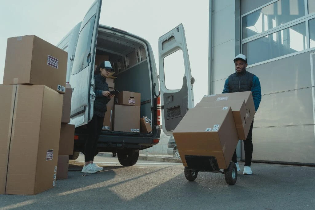Moving Business-Two men unloading boxes from van