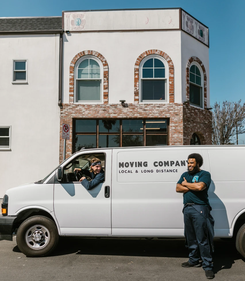 Moving Business-Van with letters "Moving Company" painted on side-two men smiling