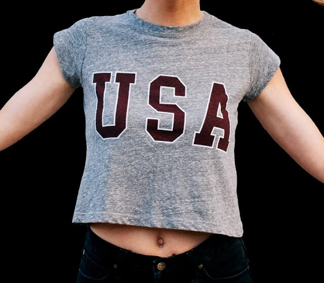 Patriotic Apparel-young woman wearing T-shirt with USA on shirt