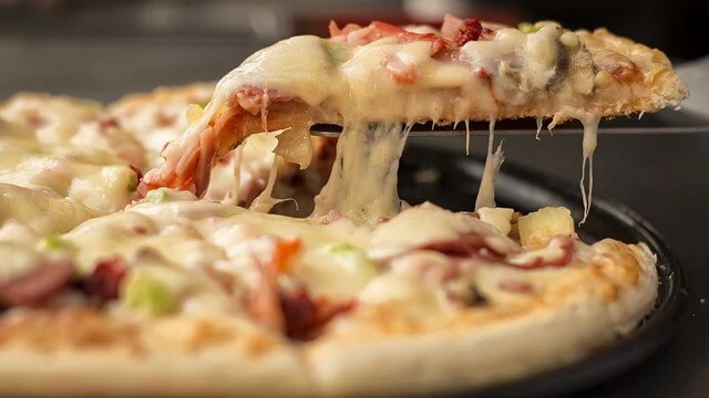Pizzeria-closeup of fresh pizza slice