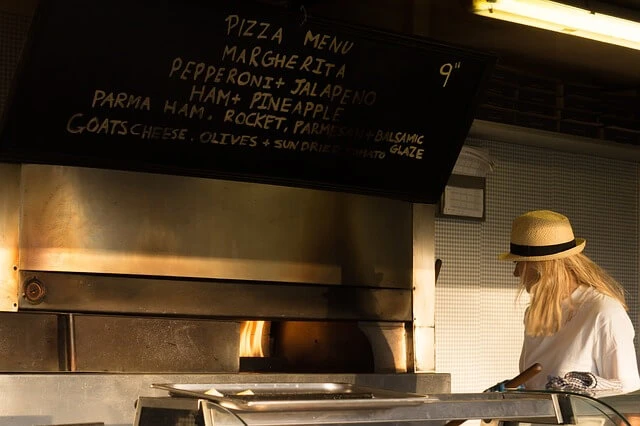 Pizzeria-Woman at pizza oven