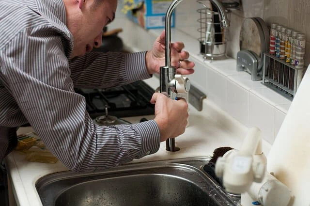 Plumbing Business-plumber fixing kitchen sink faucet