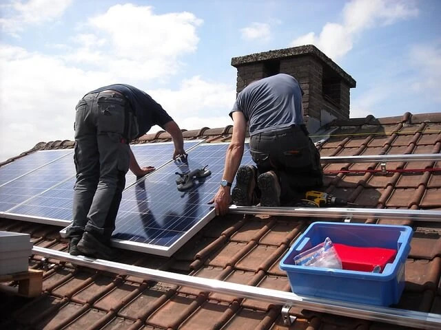 Solar Business-two men installing sloar panels on roof