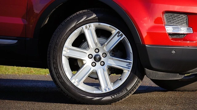 Tire Center-closeup of red car with custom tires on custom rim
