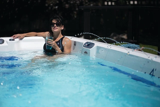 Hot Tub Business-Woman with sunglasses drinking a beverage sitting in hot tub