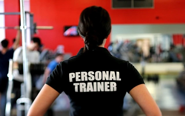 Personal Trainer - Back of woman with black T-shirt that has he words "Personal Trainer"