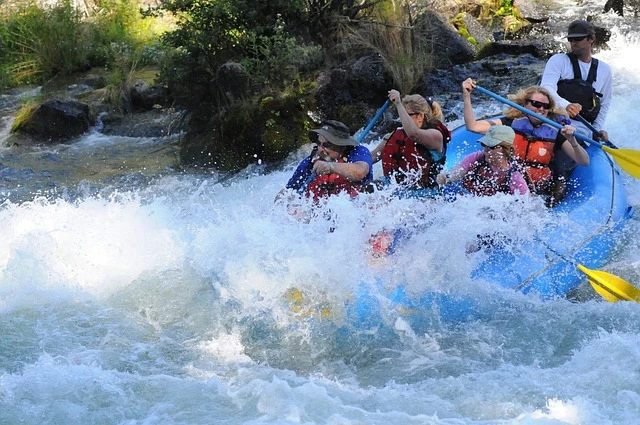 River Rafting guide business-people on raft going through whitewater 